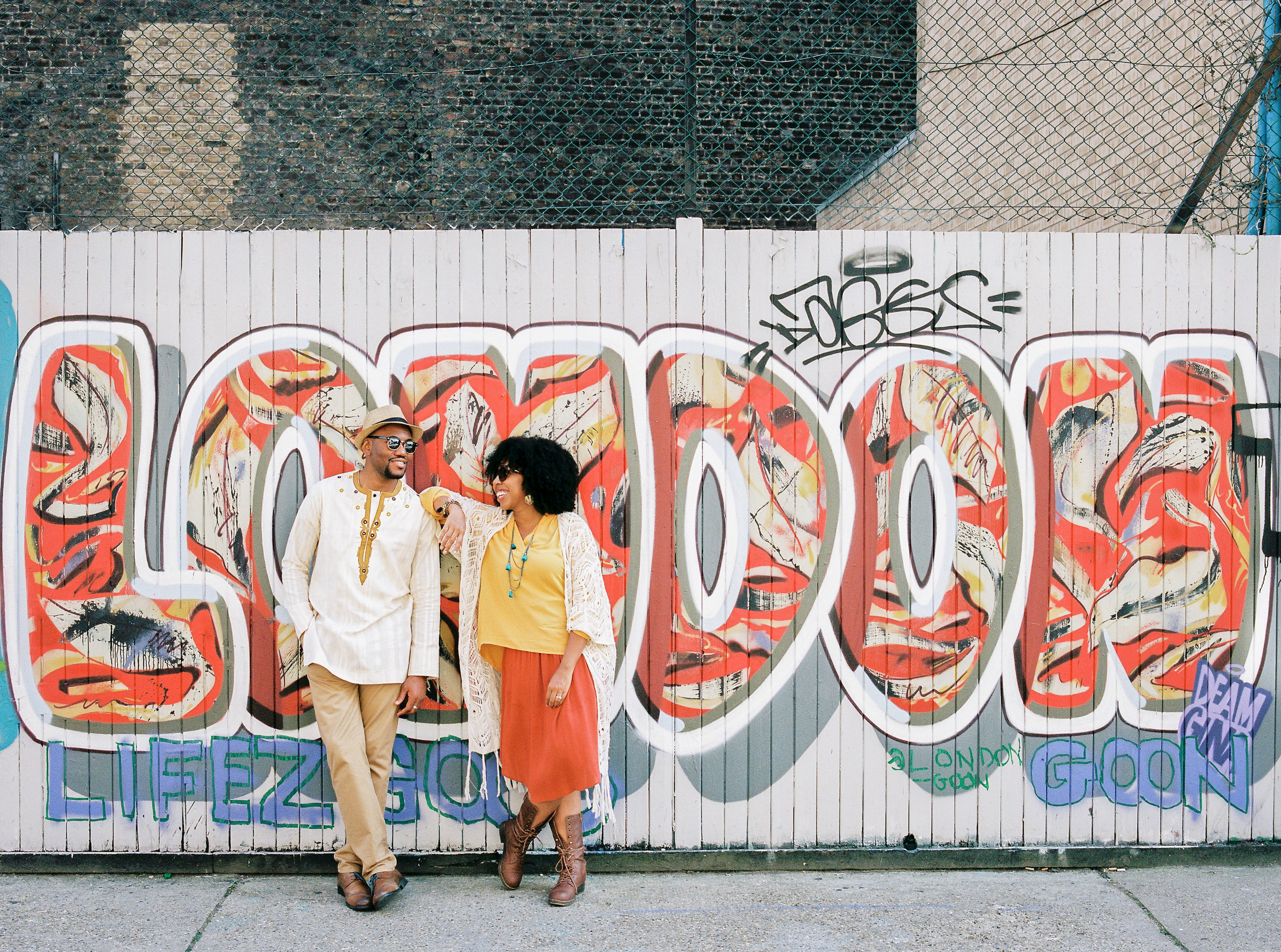 Black Couple Standing in Front of London Graffiti