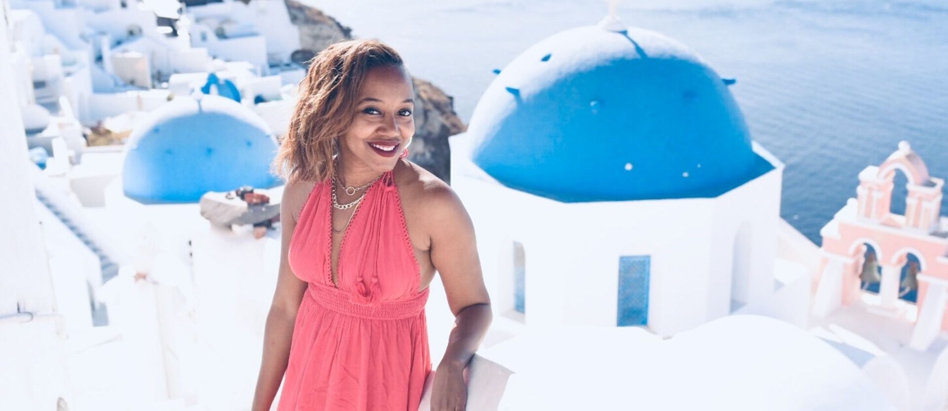Black Woman in a red dress in Greece